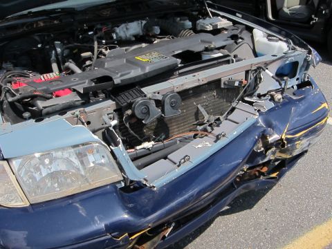1991 Ford LTD Crown Victoria - Front end collision damage to a 1991 Ford Crown Victoria LTD, showing the engine compartment.