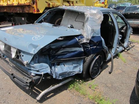 1991 Ford LTD Crown Victoria - This heavily damaged 1991 Ford Crown Victoria LTD shows significant front-end and side impact damage, with the number 85 marked on the hood.