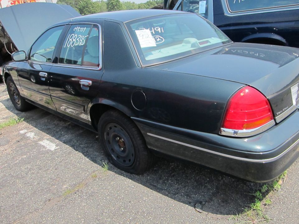 Dark sedan with hood up, parked next to a dark SUV
