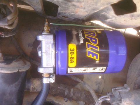 1995 Ford Bronco - Close-up of a Triple brand fuel filter assembly with part number 30-8A.
