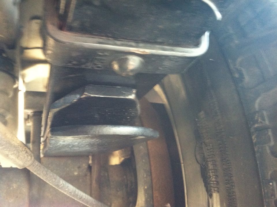 Close-up of suspension part and tire tread