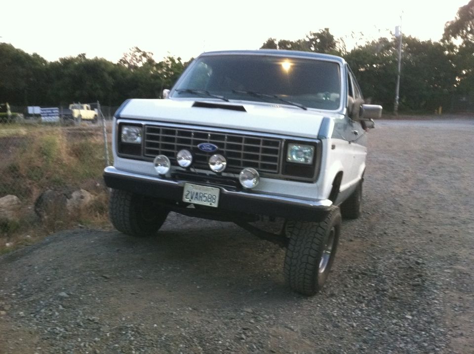White and blue van with spotlights and off-road tires. 1991 Ford E250