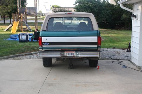1996 Ford Bronco - This 1996 Ford Bronco is seen from the rear, a two-tone green and white paint scheme with a tan removable top.