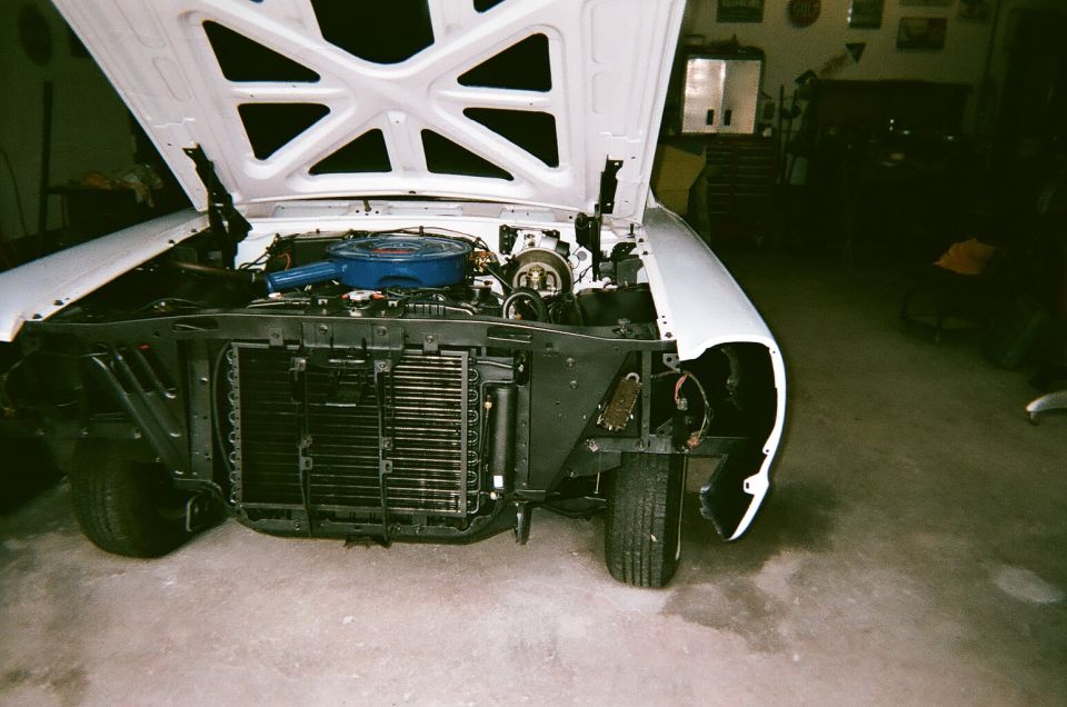 1967 Ford Galaxie engine bay with hood open, white exterior