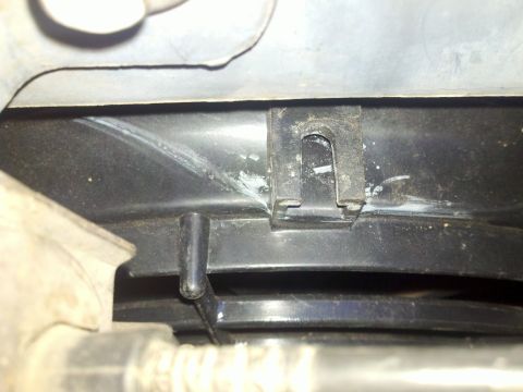 1986 Ford Bronco - Detail of a vehicle's cooling fan shroud, showing a plastic housing and metal clip.