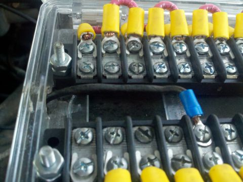 1986 Ford Bronco - This image shows a close-up view of an automotive fuse box with several electrical connections.