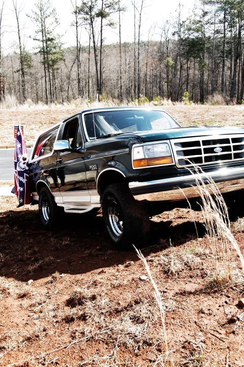 1993 Ford Bronco - This 1993 Ford Bronco is seen from a three-quarter front angle, with a Confederate flag attached to its rear.