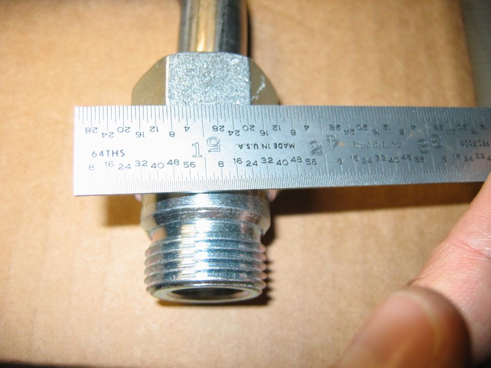 Metal fitting measured with a ruler showing approximately 1.5 inches