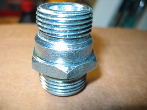 1992 Ford Bronco - A close-up view of a metal threaded fitting with a hexagonal base.