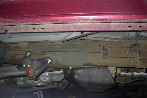 1994 Ford Bronco - Close-up of the undercarriage, focusing on suspension parts and the vehicle's frame.