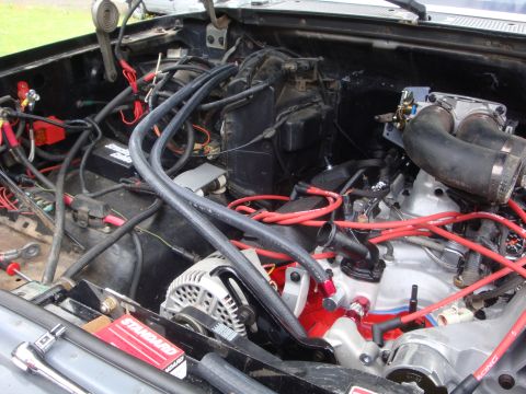 1989 Ford Bronco - Close-up view of a vehicle's engine bay, showing various components and wiring.