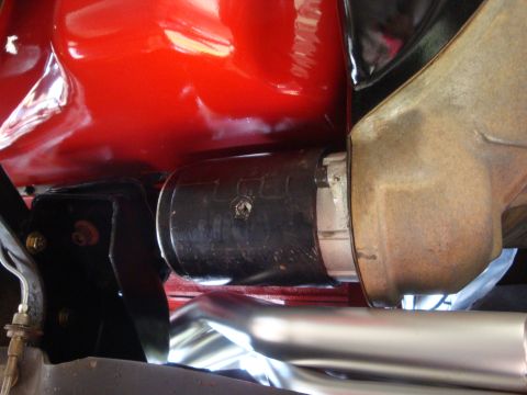 1989 Ford Bronco - Detail of an engine component, showing mechanical parts and painted surfaces.