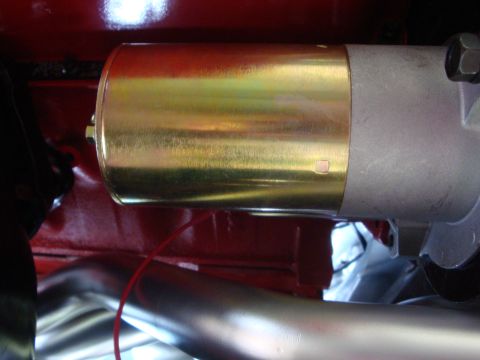 1989 Ford Bronco - Starter motor assembly with exhaust pipe visible in foreground.