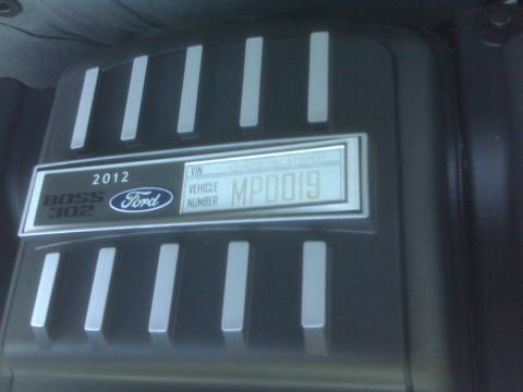 1973 Ford Mustang - The engine cover displays '2012 Ford BOSS 302' and a vehicle number.