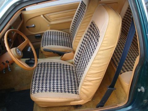 1991 Ford LTD Crown Victoria - The interior of a car features tan seats with a distinctive houndstooth pattern on the seat inserts.