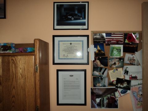 2004 Mercury Grand Marquis - A framed photograph shows a black 2004 Mercury Grand Marquis from a three-quarter front angle.