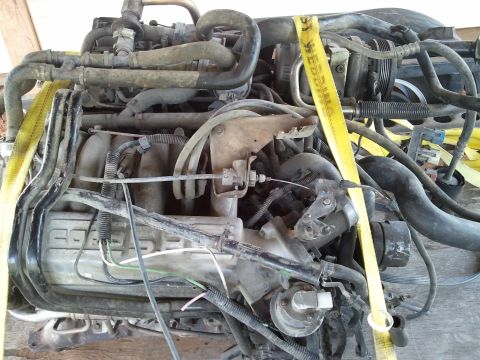 1989 Ford Bronco - Engine components are visible with yellow straps securing the assembly.