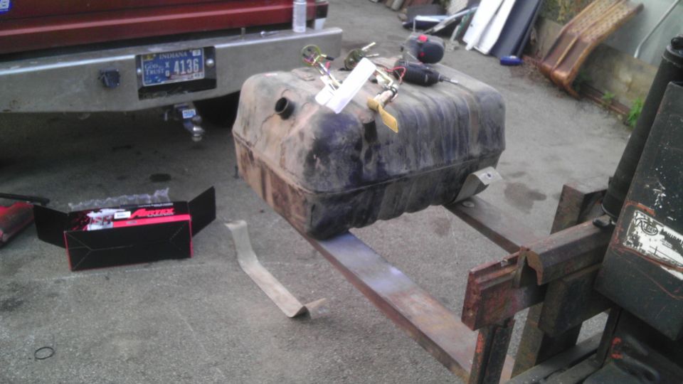 Fuel tank on forklift, with new parts box and truck bumper visible