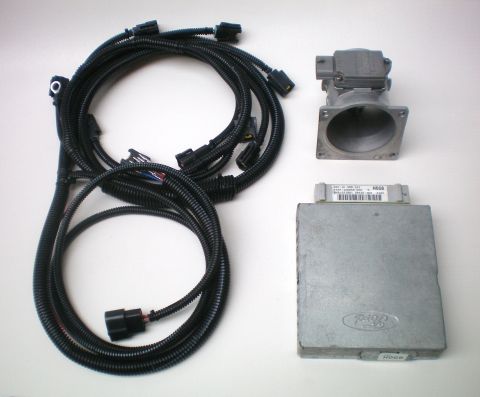 1990 Ford Bronco - Mass Air Sensor, wiring harness, and ECU are laid out on a white surface.