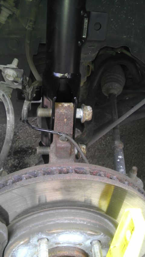 2007 Dodge Caliber - Front suspension strut and brake rotor assembly of a vehicle.