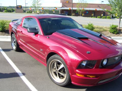 2007 Ford Mustang - A red 2007 Ford Mustang GT is parked in a lot with a Sonic restaurant in the background.