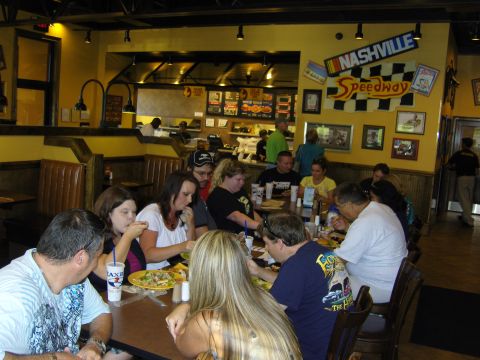 2007 Ford Mustang - A group of people are dining inside a restaurant decorated with Nashville Speedway memorabilia.