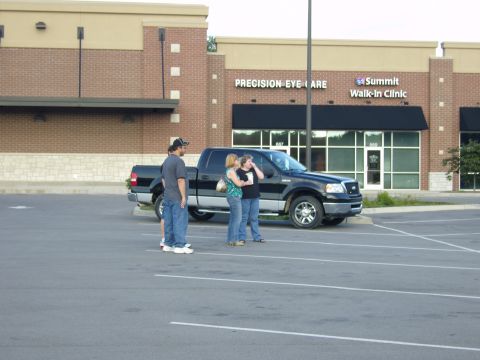 2007 Ford Mustang - A black Ford F-150 pickup truck is parked in front of a strip mall with 'Precision Eye Care' and 'Summit Walk-In Clinic' signs.