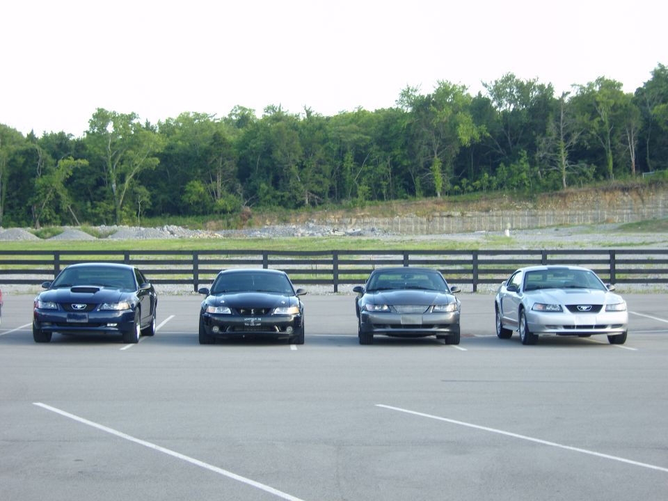 Four 2007 Ford Mustangs parked in a lot, front view