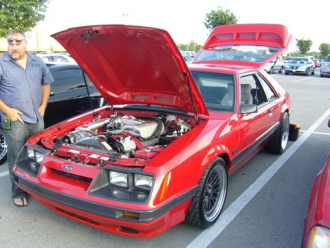 2007 Ford Mustang - A red 1987 Ford Mustang coupe is shown with its hood and trunk open, revealing the engine bay.