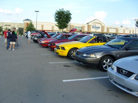 2007 Ford Mustang - A group of Ford Mustangs are gathered in a parking lot with a Kroger store visible in the background.