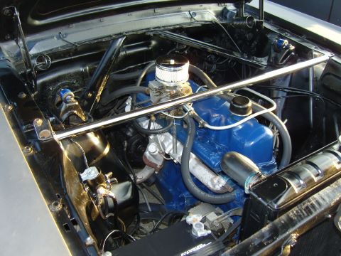 2007 Ford Mustang - The engine bay features bright blue valve covers and a chrome air cleaner assembly, complemented by a polished strut tower brace.