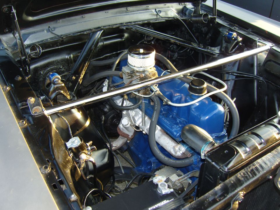 Engine bay with blue valve covers, chrome air cleaner, and strut tower brace