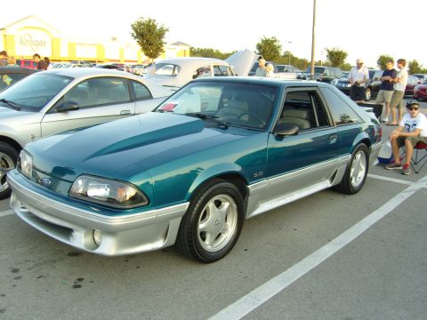 2007 Ford Mustang - A teal and silver Ford Mustang GT from the early 1990s is displayed at a car meet.