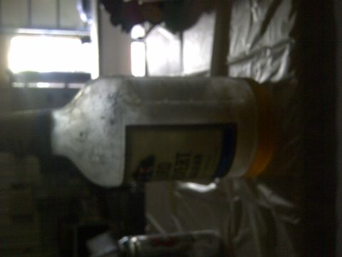 1994 Ford F-150 - A blurry image shows a white vehicle part with a yellow cap and a label.