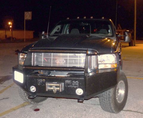 2006 Ford E350 - This truck features a heavy-duty aftermarket bumper and a chrome grille, suggesting a model year around 2005.