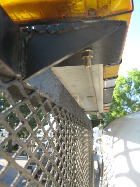 1972 Ford F-250 - Detail of a truck bed structure and a light bar, with another vehicle nearby.