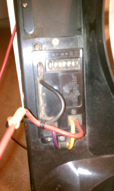 1990 Ford Bronco - An automotive electrical component with a digital odometer and connected wiring is shown in this close-up view.