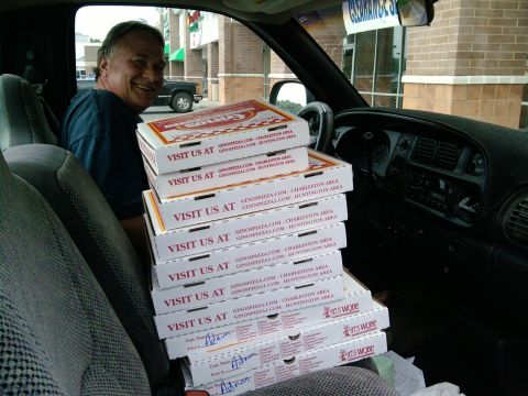 1985 Ford Crown Victoria LTD - A man sits in a vehicle, surrounded by a large order of pizza boxes from Gino's Pizza.