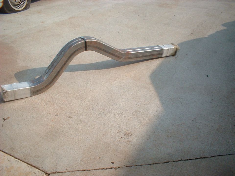 Exhaust pipe section on concrete, wrapped ends, metal bands