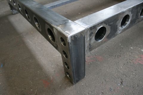 1973 Ford Ranchero - Close-up of a custom-fabricated steel frame structure with round perforations.