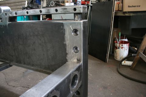 1973 Ford Ranchero - A metal frame structure is shown in a workshop with tools and materials in the background.