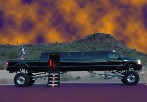 1992 Ford Bronco - A heavily modified black truck transformed into a limousine, parked outdoors with a dramatic sky.