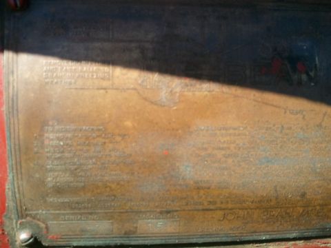 1985 Ford F-150 - A close-up view of a tarnished metal data plate, embossed text and a serial number, likely from a piece of equipment.