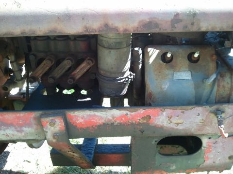 1985 Ford F-150 - The engine components of an old tractor show significant rust and wear.