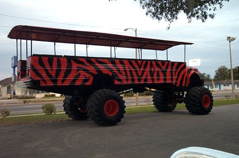 1992 Ford Bronco - This heavily modified truck features large tires and a unique tiger stripe paint scheme.