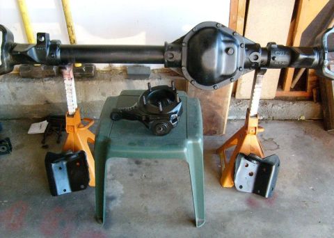 1996 Ford Bronco - A disassembled rear axle assembly is shown, likely for a Ford vehicle, resting on jack stands.
