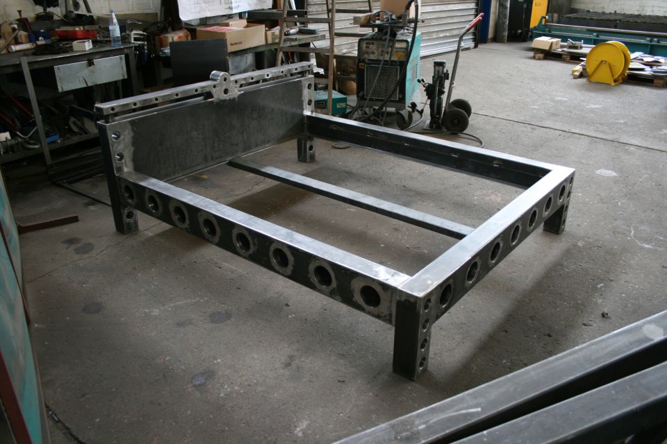Metal bed frame with circular cutouts on the side rails