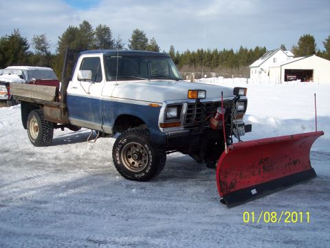 1973 Ford F-250 - This truck is equipped with a snow plow and is ready for winter conditions.