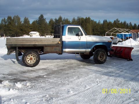 1973 Ford F-250 - This 1973 Ford F-250 flatbed truck is equipped with a snow plow for winter use.