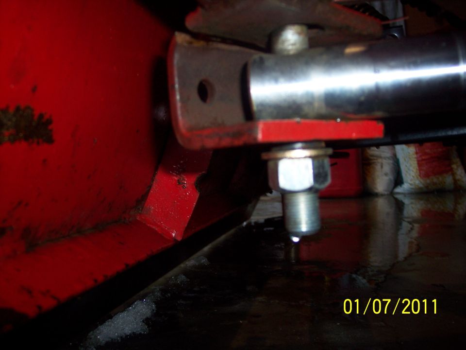 Close-up of red plow attachment with bolt and metal bracket